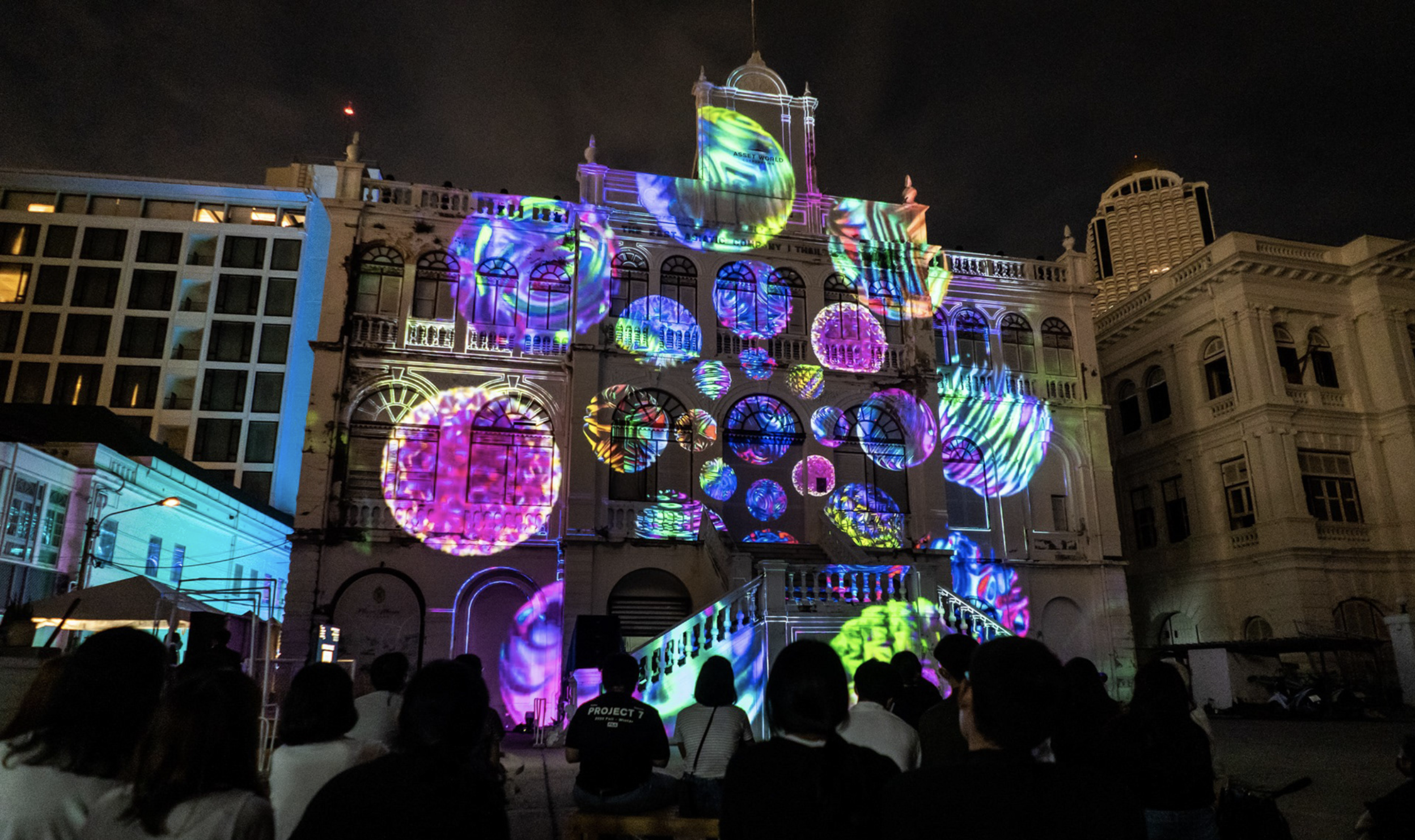 Light projection of marbles in bright colours projected on a historical building