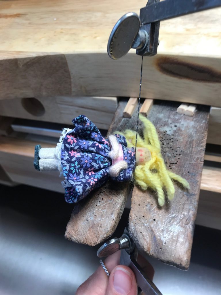Girl in blue dress sculpture, chopping off the head