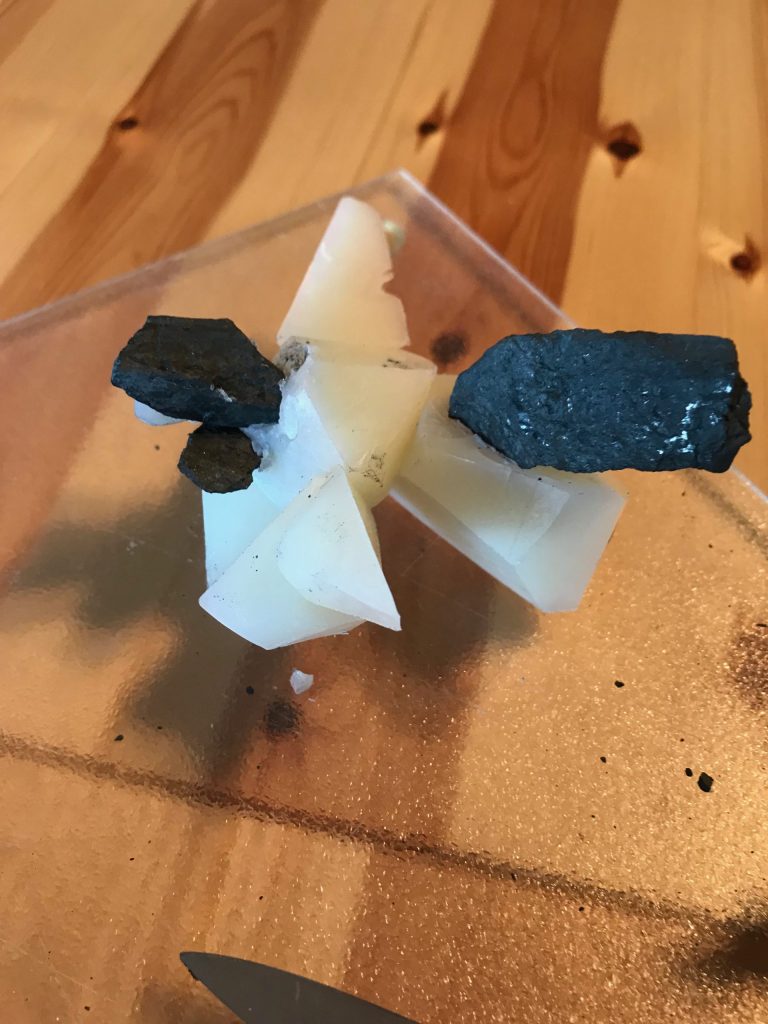 Sculpture building with white soap and black rock
