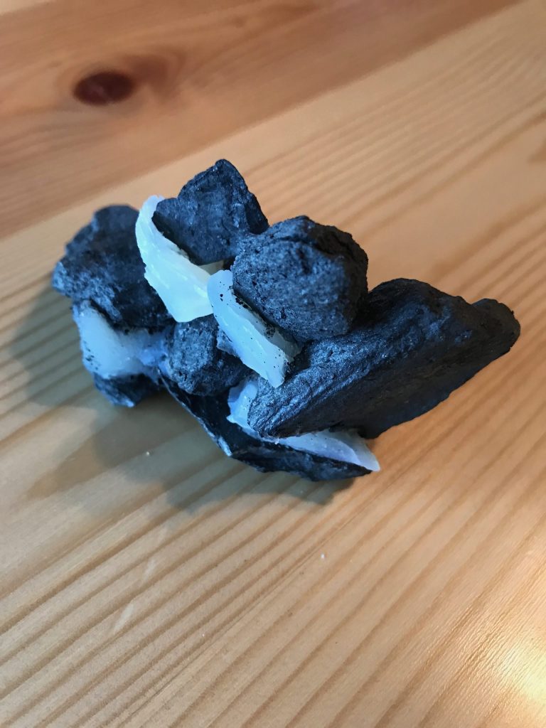 Sculpture building with white soap and black rock