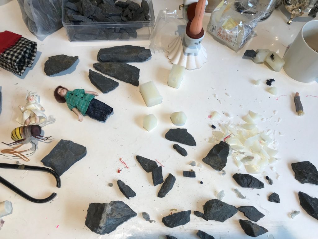 Rocks, soaps and dolls on studio table