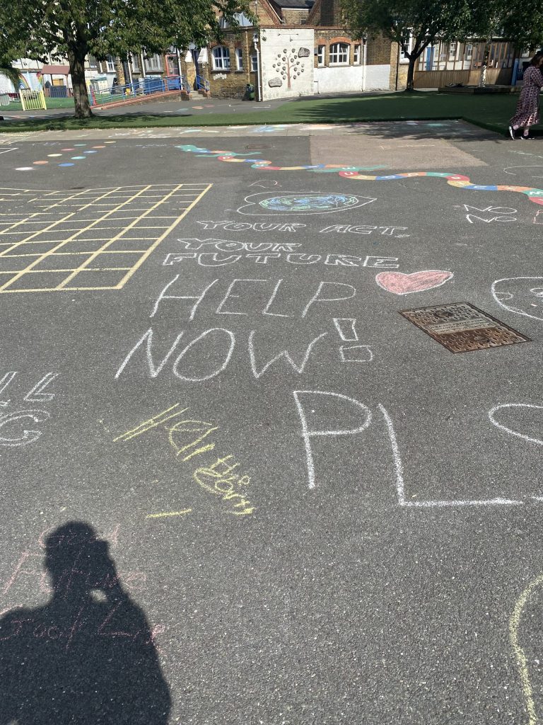 Chalk drawings done by children on the playground floor